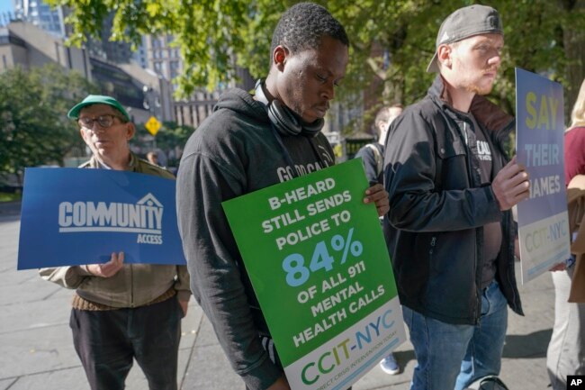 FILE - Activists participate in a rally to call for peer-led, non-police response to mental health crisis calls, Thursday, Sept. 29, 2022, in New York. The Associated Press has found that 14 of the 20 most populous U.S. cities are experimenting with removing police from some nonviolent 911 calls and sending behavioral health clinicians. Initiatives in major cities including New York, Los Angeles, Columbus, Ohio, and Houston had combined annual budgets topping $123 million as of June 2023. (AP Photo/Mary Altaffer)