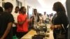 A student at Malawi University of Science and Technology explains artificial intelligence products to education minister Madalitso Kambauwa Wirima. (Lameck Masina/VOA)