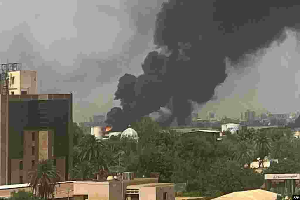 Smoke billows above residential buildings in Khartoum as fighting in Sudan raged for a second day in battles between rival generals.