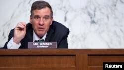 FILE - Senator Mark Warner, Democrat of Virginia and Chairman of the Senate Select Committee on Intelligence, holds a hearing n Capitol Hill in Washington, Apr. 14, 2021.
