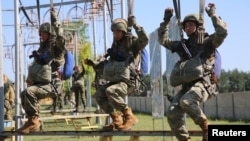 Service members take part in the "Eagle Assault" joint military exercises of the armies of Belarus and China at an undisclosed location in Belarus, in this Belarusian Defense Ministry handout picture released July 9, 2024.