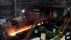 FILE - Red-hot steel rolls along a conveyor inside a mill in Yingkou, China, on July 24, 2019. Indicators suggest that the demand for steel in China will significantly decrease, but some are "cautiously optimistic" that the downturn will be slighter.