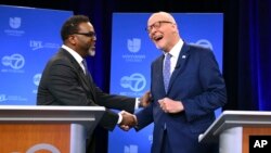 Chicago mayoral candidates Brandon Johnson, left, and Paul Vallas shake hands before the start of a debate at ABC7 studios in downtown Chicago, March 16, 2023. (Chris Sweda/Chicago Tribune via AP, Pool)