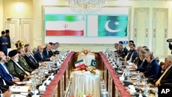 In this photo released by Press Information Department, Iranian President Ebrahim Raisi, second left, holds official talks with Pakistan's Prime Minister Shehbaz Sharif, second right, at prime minister house in Islamabad, Pakistan, April 22, 2024. 