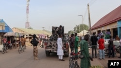 FILE - Nigerian security forces are seen in a street in Chibok, March 31, 2024. Almost 100 of the 276 girls seized from their school in Chibok by Boko Haram fighters are still thought to be in captivity. 