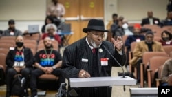 FILE - Bishop Henry Williams of Oakland, California, testifies during the Reparations Task Force meeting in Sacramento, March 29, 2023. Williams said he hopes to build a Black Wall Street in Oakland with all Black-owned businesses. 