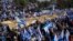 Israelis wave the national flag and carry a large copy of the Israeli Declaration of Independence to protest plans by the government to overhaul the judicial system outside the Knesset, Israel's parliament, in Jerusalem, Feb. 20, 2023. 