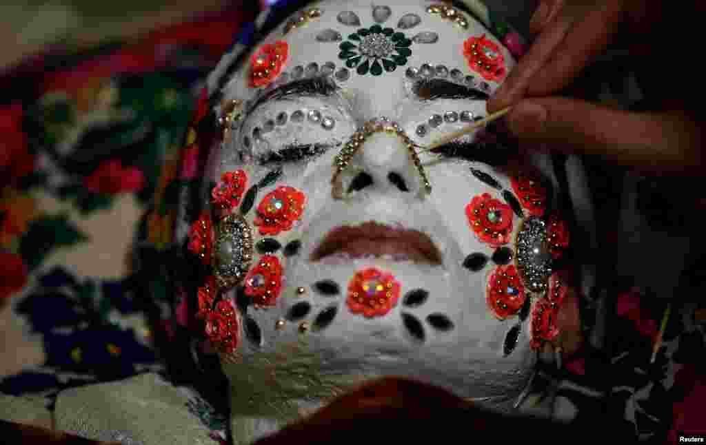 Bulgarian Muslim bride Aysel Gerova, 24, has makeup applied to her face during her wedding ceremony in the village of Ribnovo, in the Rhodope Mountains, Dec.17, 2023.