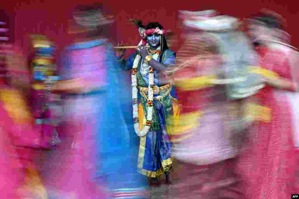 A college student dresses in the guise of Hindu deity Krishna, ahead of Janmashtami festival, in Chennai, India.