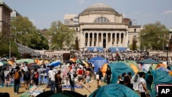 FILE - Student protesters gather inside their encampment on the Columbia University campus, April 29, 2024, in New York. (AP Photo/Stefan Jeremiah, File)