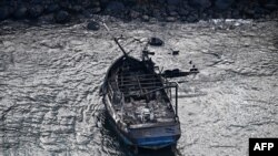 An aerial image taken on Aug. 10, 2023, shows a burned boat in the Lahaina Harbor after wildfires swept through western Maui, Hawaii.