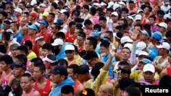 Participants wait before the Beijing Marathon, at Tiananmen Square in Beijing, Oct. 29, 2023. 