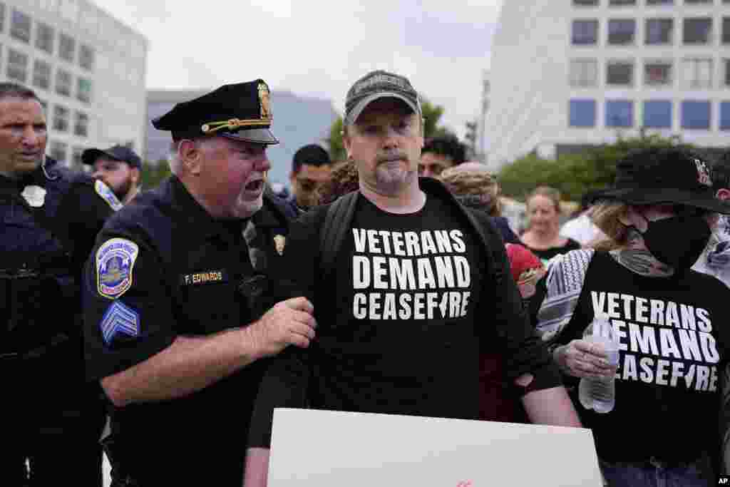 Washington Metropolitan Police clear demonstrators from blocking traffic in Washington, ahead of a scheduled visit by Israeli Prime Minister Benjamin Netanyahu at the U.S. Capitol.