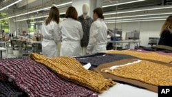 Knitwear created by Italian artisans for the Prada and Miu Miu brands sits on a desk at a recently expanded factory in the Perugia province of Italy, May 7, 2024.