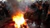 Supporters of Thailand's Move Forward Party burn an effigy during a protest at Pheu Thai party headquarters in Bangkok on Aug. 2, 2023.