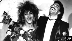 FILE - In this Feb. 27, 1985 file photo, Tina Turner, left, and Lionel Richie pose with their awards at the Grammy Awards show in Los Angeles. Turner won Female Pop Vocal Performance, Record of the Year and Female Rock Vocalist.