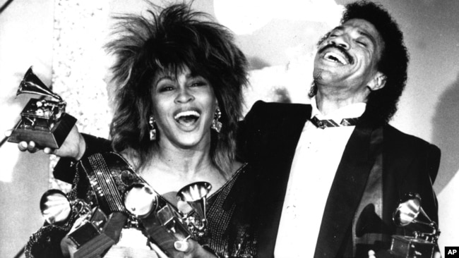 FILE - In this Feb. 27, 1985 file photo, Tina Turner, left, and Lionel Richie pose with their awards at the Grammy Awards show in Los Angeles. Turner won Female Pop Vocal Performance, Record of the Year and Female Rock Vocalist.