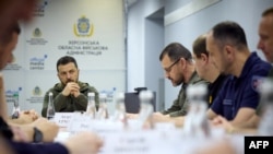 President Volodymyr Zelenskyy attends a meeting June 8, 2023, with city authorities during his visit in Kherson, following floods and damage sustained at the Kakhovka hydroelectric power plant dam. (Ukrainian Presidential Press Service / AFP)