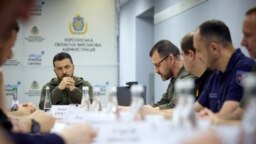 President Volodymyr Zelenskyy attends a meeting with the city's authorities during his visit in Kherson, following floods and damages sustained at the Kakhovka hydroelectric power plant dam. (Photo by handout / Ukrainian Presidential Press Service / AFP) 