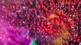 FILE - People celebrate with bright colors for Lathmar Holi at Nandagram temple in Nandgoan village, 115 kilometers (70 miles) south of New Delhi, India, March 19, 2024. (AP Photo/Rajesh Kumar Singh)