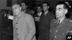 FILE - Former Iranian Prime Minister Mohammad Mosaddegh, left, is sentenced to three years solitary confinement by a military court after finding him guilty on 13 charges of acting against the shah, in Tehran, Iran on Dec. 21, 1953.