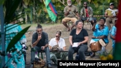 From left to right, journalists Mathurin Derel, Coralie Cochin and Charlotte Mannevy are reporting at a religious service held in a suburb of New Caledonia's capital Noumea on June 2, 2024. (Photo - courtesy of Delphine Mayeur)