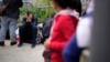 FILE - People waiting to apply for asylum camp near the pedestrian entrance to the San Isidro Port of Entry, linking Tijuana, Mexico, with San Diego, June 1, 2023, in Tijuana.