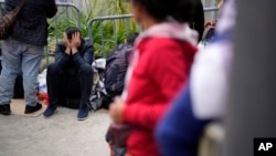 FILE - People waiting to apply for asylum camp near the pedestrian entrance to the San Isidro Port of Entry, linking Tijuana, Mexico, with San Diego, June 1, 2023, in Tijuana.