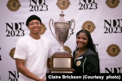 Tajaih Robinson, left, and Iyana Trotman of Wake Forest University hold the National Debate Tournament winner's trophy, Monday, April 4, 2023 in Chantilly, Virginia. (Photo courtesy of Claire Brickson)