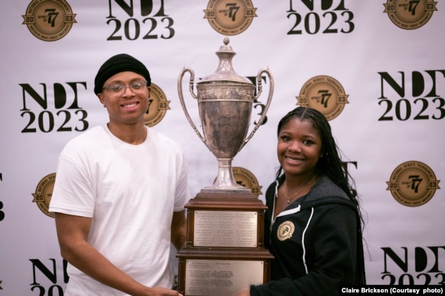 Tajaih Robinson, left, and Iyana Trotman of Wake Forest University hold the National Debate Tournament winner's trophy, Monday, April 4, 2023 in Chantilly, Virginia. (Photo courtesy of Claire Brickson)