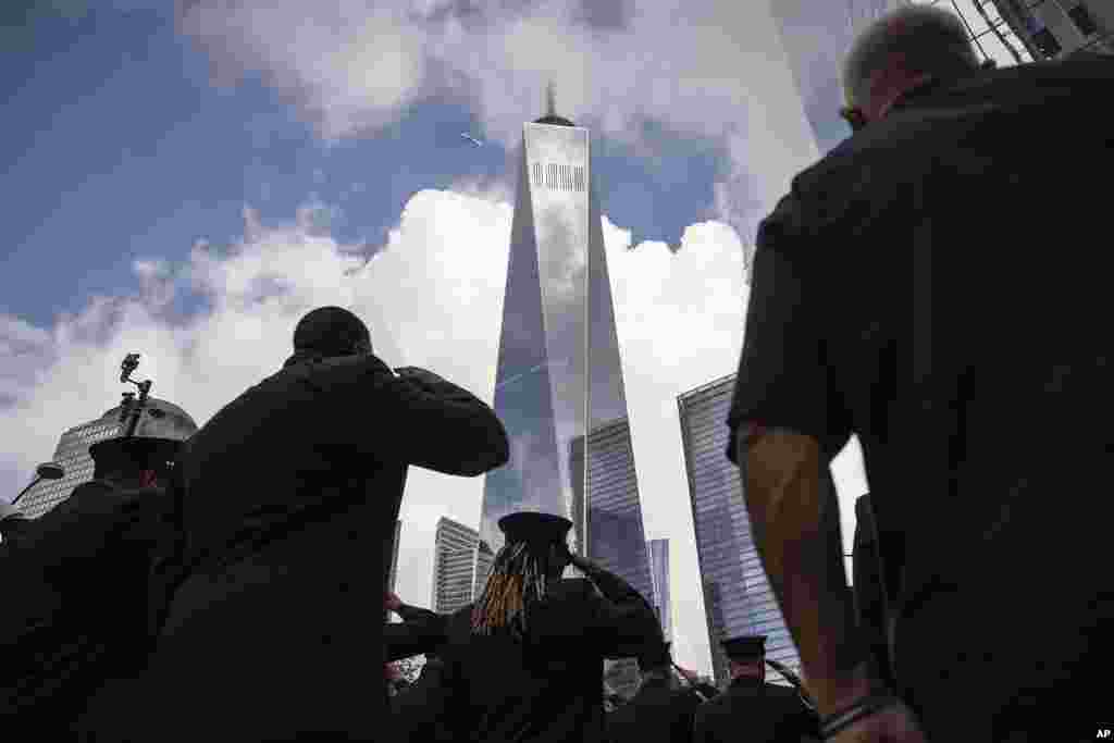 Firefighters salute during a moment of silence outside the commemoration ceremony on the 22nd anniversary of the September 11, 2001, terror attacks, in New York.