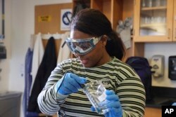 Terrica Purvis, a student, in Chemistry 121 class at Everett Community College tests the pH balance of a buffer solution and water, March 10, 2023. Purvis is in her first year of study for an associate degree in nursing at Everett Community College.