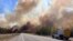 Smoke column rises from a wildfire near Wildwood, Alberta, Canada, May 5, 2023. 