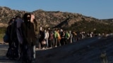 FILE - Chinese migrants wait to be processed after crossing the border with Mexico, May 8, 2024, near Jacumba Hot Springs, California.