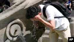 A man cools off at a fountain in Rome, Aug. 22, 2023. 