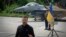 Ukraine's President Volodymyr Zelenskyy answers media questions standing against the backdrop of an F-16 fighter jet at an undisclosed location in Ukraine, Aug. 4, 2024.