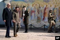 US President Joe Biden, left, walks with Ukrainian President Volodymyr Zelenskyy at St. Michaels Golden-Domed Cathedral during an unannounced visit, in Kyiv, Ukraine, Monday, Feb. 20, 2023. (AP Photo/Evan Vucci)