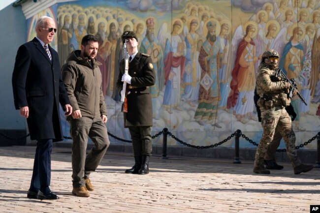 US President Joe Biden, left, walks with Ukrainian President Volodymyr Zelenskyy at St. Michaels Golden-Domed Cathedral during an unannounced visit, in Kyiv, Ukraine, Monday, Feb. 20, 2023. (AP Photo/Evan Vucci)