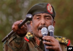 FILE - Sudanese Gen. Abdel Fattah al-Burhan speaks during a military-backed rally, in Omdurman district, west of Khartoum, Sudan, June 29, 2019.