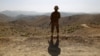 FILE - A soldier stands guard outside the Kitton outpost along the border fence on the border with Afghanistan in North Waziristan, Pakistan, on Oct. 18, 2017.