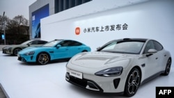 FILE - Chinese electronics company Xiaomi's first electric vehicles "Xiaomi SU7 model" are seen on display in Beijing, March 28, 2024. Prime Minister Justin Trudeau says Canada will impose a 100% tariff on the import of Chinese electric vehicles.