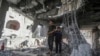 Palestinians stand in the ruins of a home after an overnight Israeli strike in Rafah, southern Gaza Strip, May 3, 2024.
