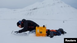 Paul Scherrer Institute Switzerland chemist Francois Burgay, 34, prepares to take a snow sample to detect molecules connected to algal bloom in Ny-Aalesund, Svalbard, Norway, April 5, 2023.