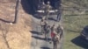 This image made from video provided by WCVB-TV shows Jack Teixeira, in T-shirt and shorts, being taken into custody by armed tactical agents on April 13, 2023, in Dighton, Mass.