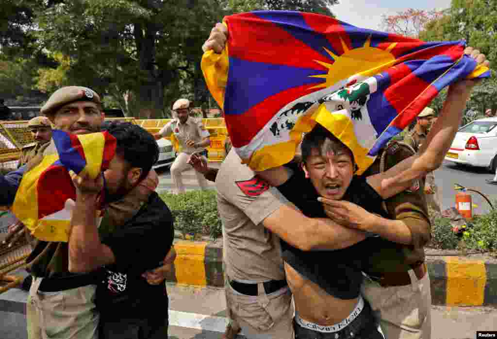 Tibetan exiles are detained by police during a protest against the visit of Chinese Foreign Minister Qin Gang, who is scheduled to participate in the G-20 foreign ministers&#39; meeting, near the Chinese embassy in New Delhi, India.