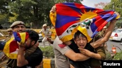 Tibetan exiles are detained by police during a protest against the visit of Chinese Foreign Minister Qin Gang, who is scheduled to participate in the G-20 foreign ministers&#39; meeting, near the Chinese embassy in New Delhi, India.