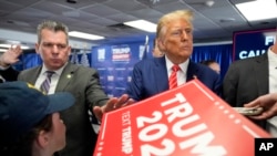 Republican presidential candidate former President Donald Trump signs autographs after speaking at a rally at Des Moines Area Community College in Newton, Iowa, Jan. 6, 2024.