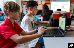 Fifth grade students work on computers during a math class at Mount Vernon Community School, in Alexandria, Va., Wednesday, May 1, 2024. (AP Photo/Jacquelyn Martin)