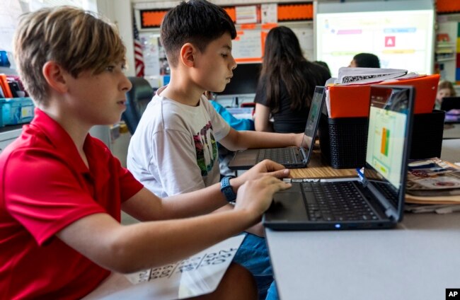 Fifth grade students work on computers during a math class at Mount Vernon Community School, in Alexandria, Va., Wednesday, May 1, 2024. (AP Photo/Jacquelyn Martin)