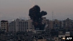 Smoke rises above buildings in Gaza City as Israel launched air strikes on the Palestinian enclave early on Feb. 23, 2023. 